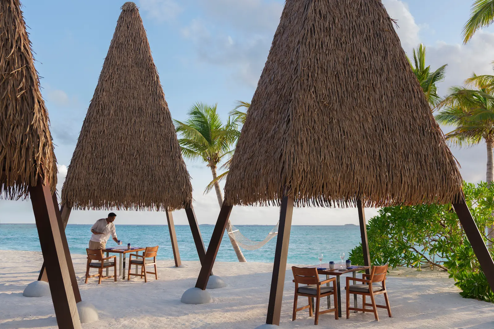 heritance aarah maldives ginifati restaurant daylight showcasing an elegant oceanfront dining setting with refined tropical ambience and soft natural lighting
