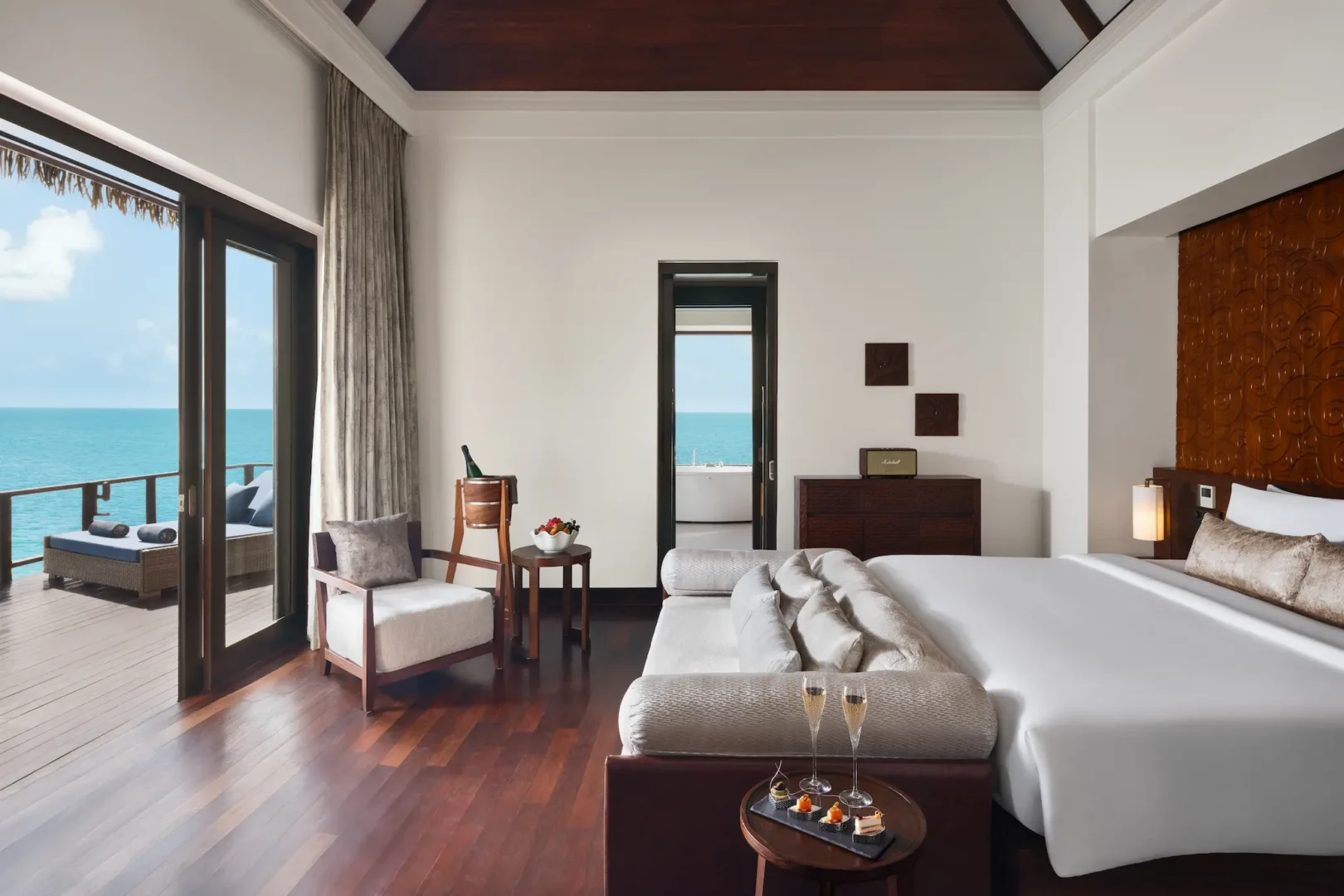 heritance aarah maldives ocean residence downstairs room featuring an elegant overwater interior with refined natural textures and a serene lagoon facing ambience