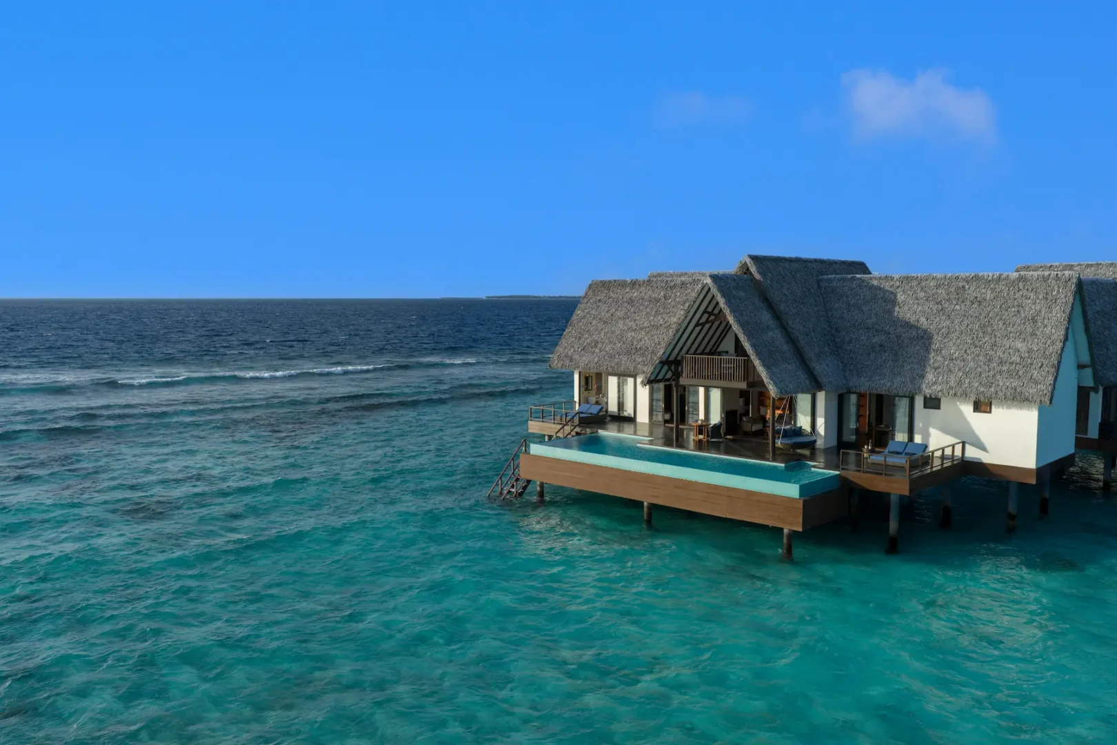 heritance aarah maldives ocean residence facade daylight showcasing an elegant overwater exterior illuminated by soft natural light and surrounded by a tranquil turquoise lagoon
