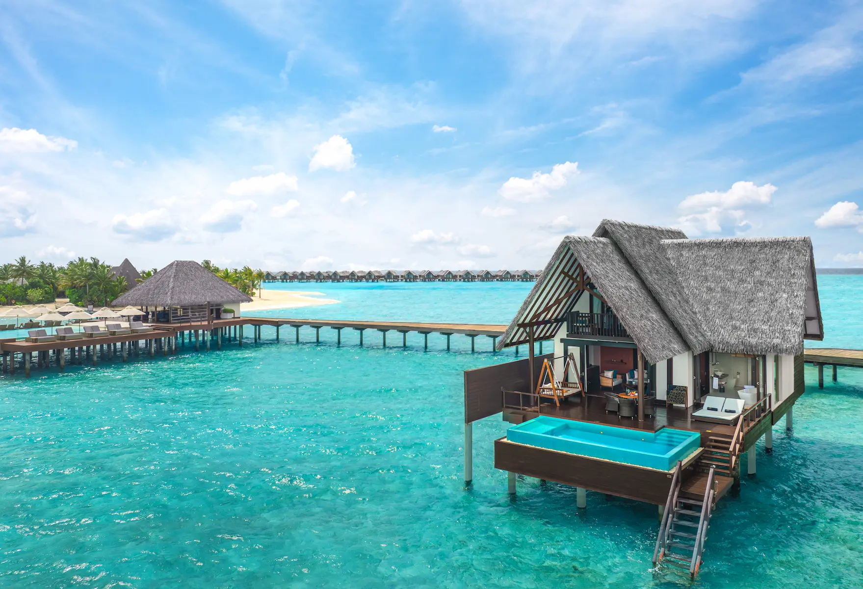 heritance aarah maldives ocean suite aerial facade showcasing an elegant overwater residence surrounded by a serene turquoise lagoon