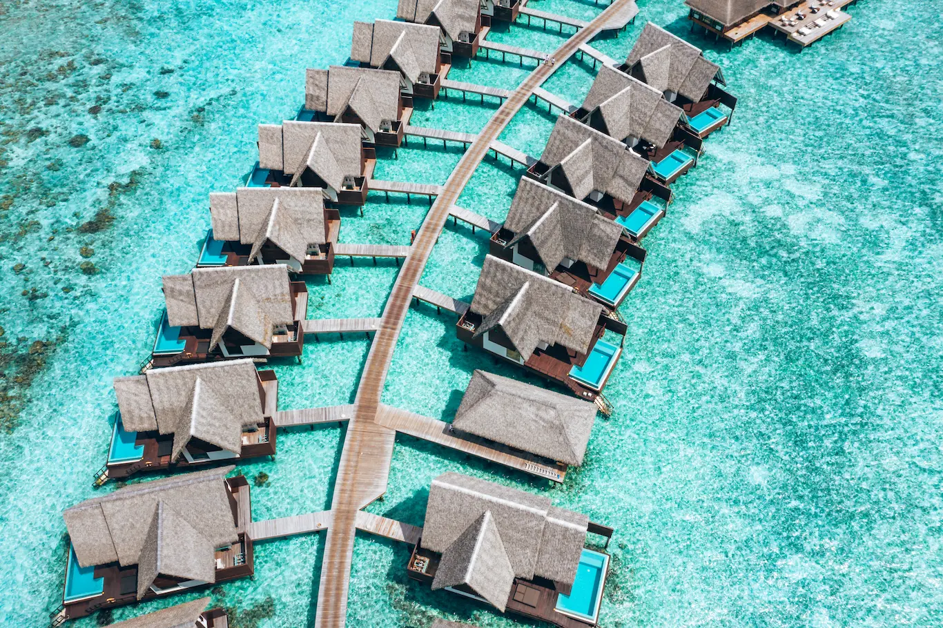 heritance aarah maldives ocean suite jetty extending over a tranquil turquoise lagoon with elegant overwater ambience
