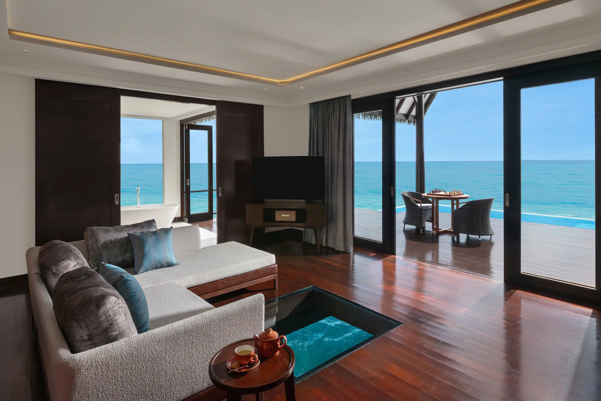 heritance aarah maldives ocean suite living room featuring an elegant overwater interior with refined natural textures and serene lagoon views