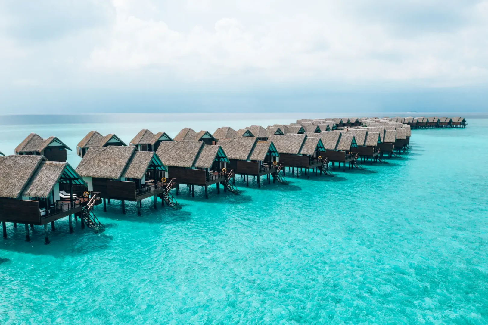 heritance aarah maldives ocean villa jetty extending over a tranquil turquoise lagoon with elegant overwater ambience