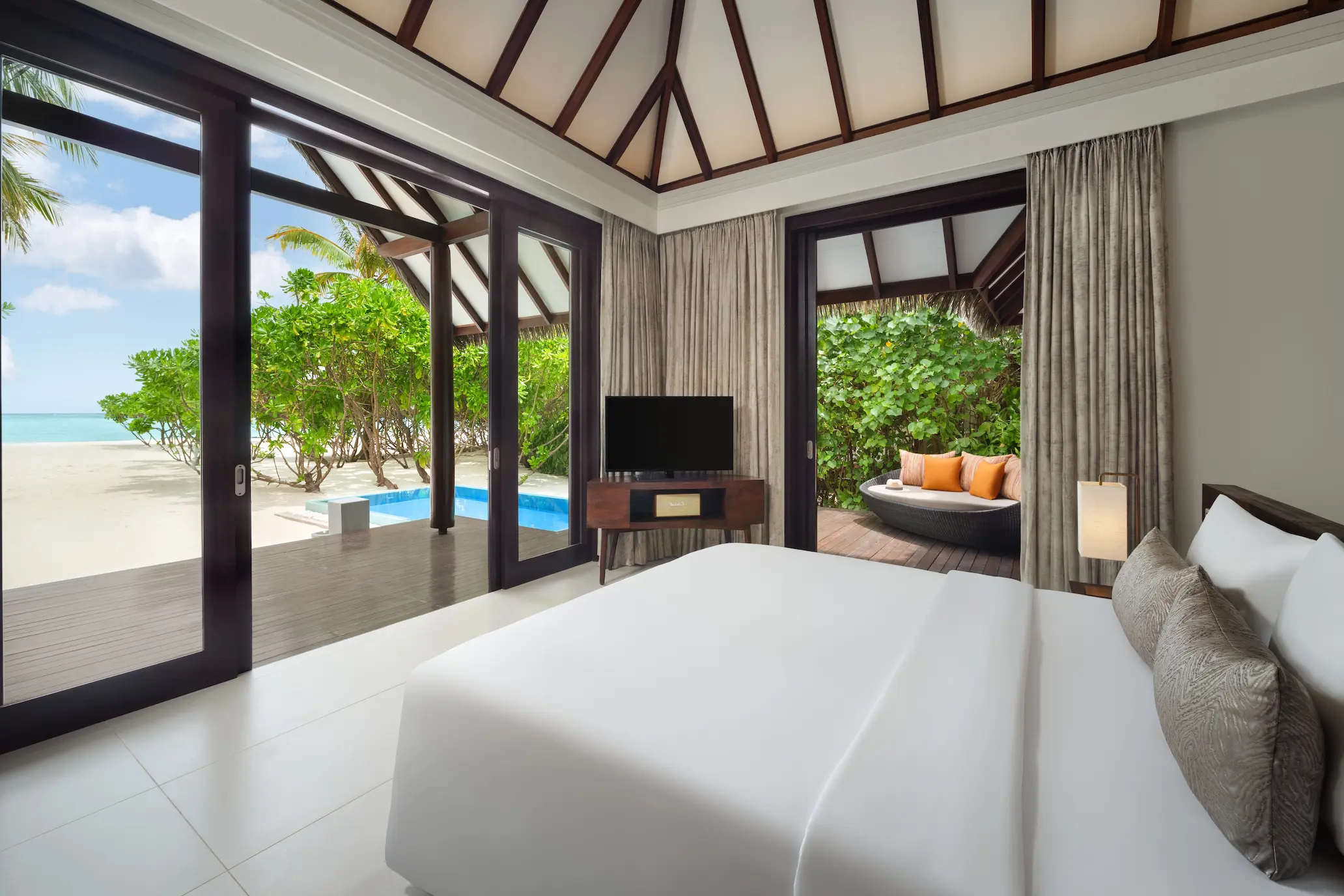 heritance aarah maldives pool beach villa room featuring a refined beachfront interior with warm natural textures and serene tropical ambience
