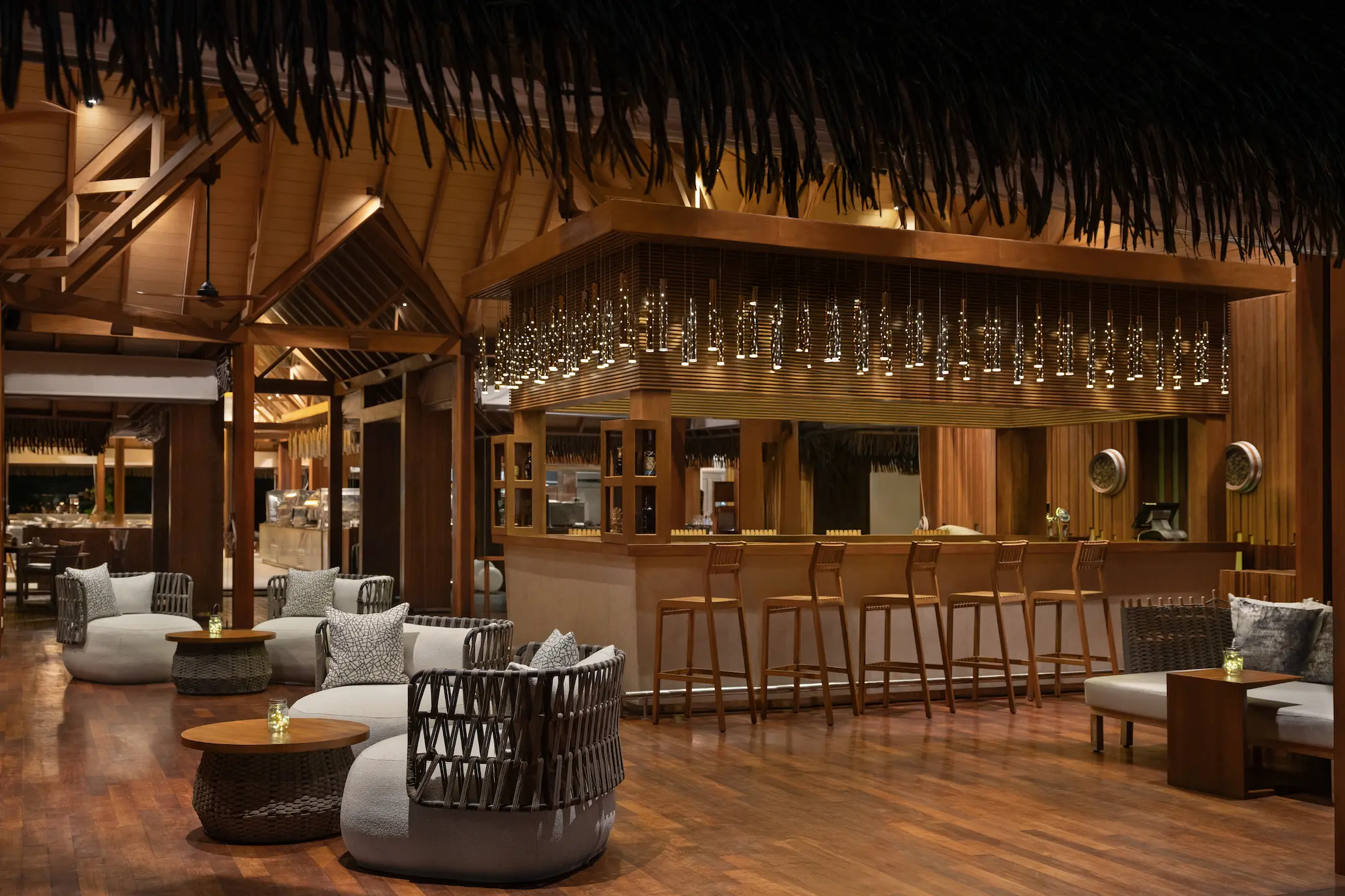 heritance aarah maldives ralu lounge bar night view showcasing an elegant beachfront setting with warm ambient lighting and serene evening atmosphere