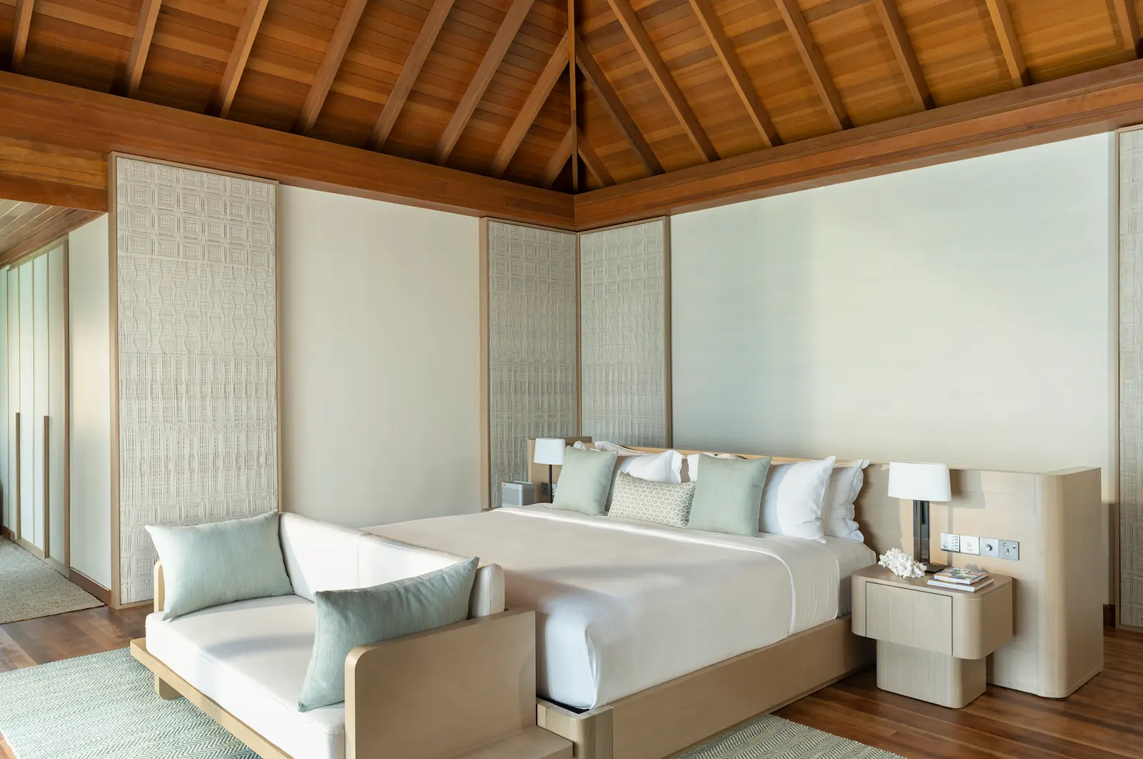 huvafen fushi maldives ocean bungalow with pool bedroom featuring a serene overwater sleeping space with elegant textures and calming lagoon views