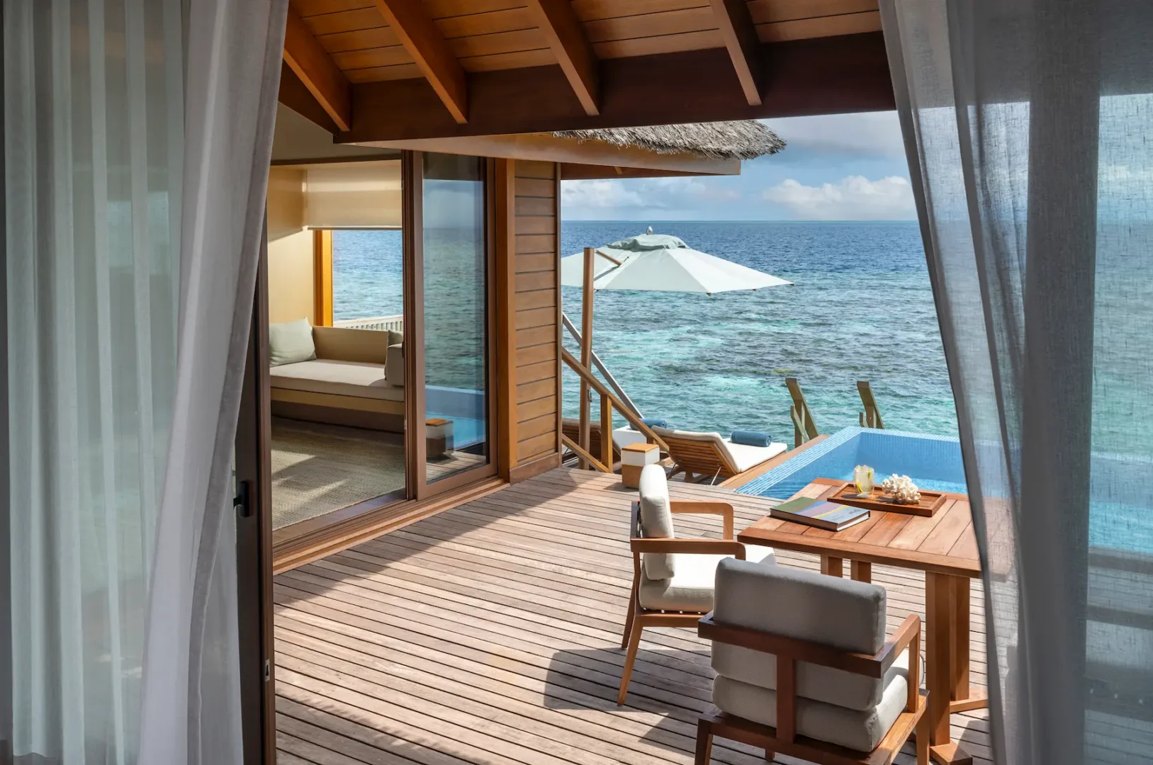 huvafen fushi maldives ocean bungalow with pool deck offering a serene overwater lounging space with calm lagoon views and refined island ambience