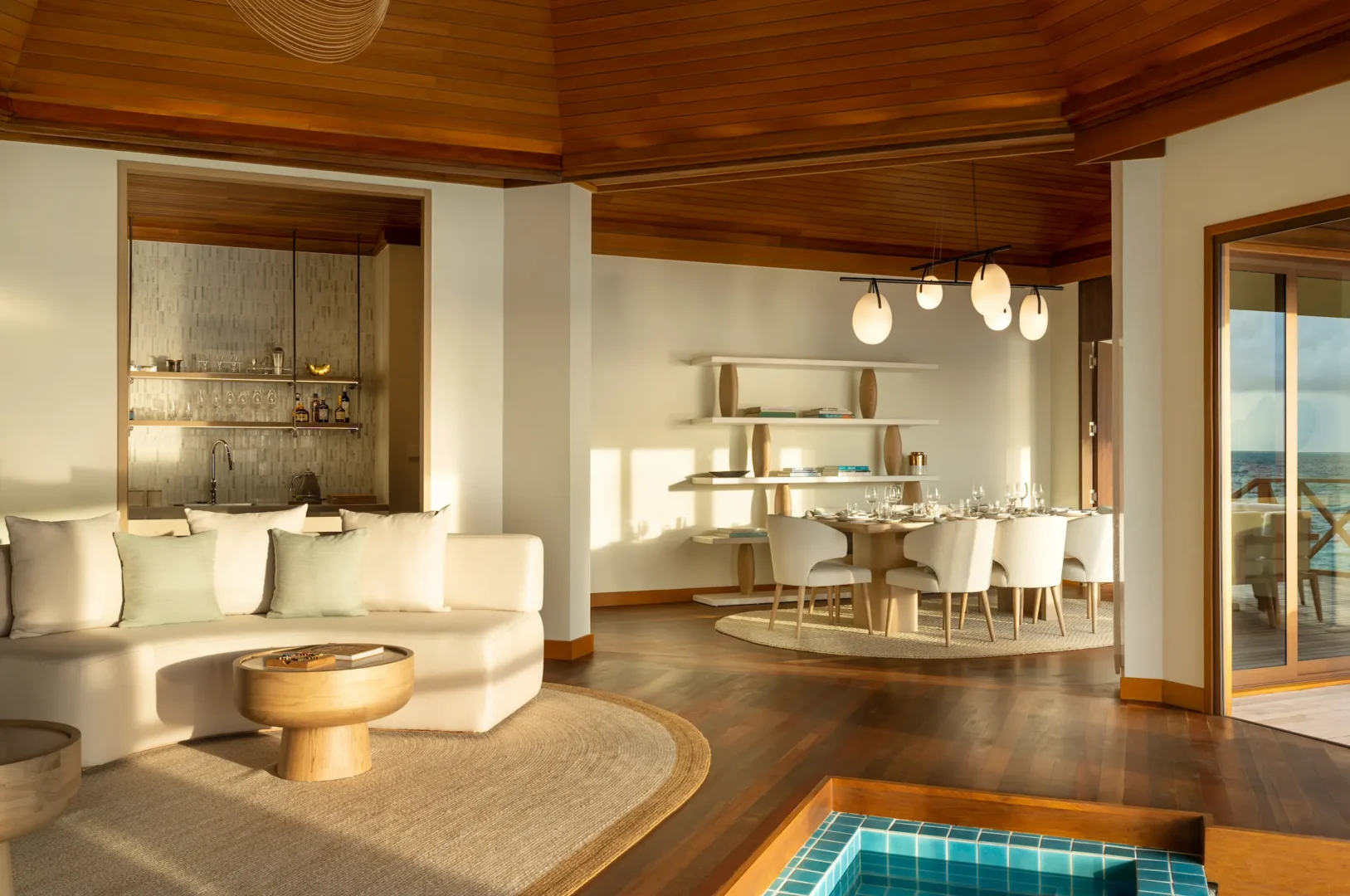 huvafen fushi maldives ocean pavilion with pool afternoon light showcasing a serene overwater residence bathed in warm soft light with tranquil lagoon views