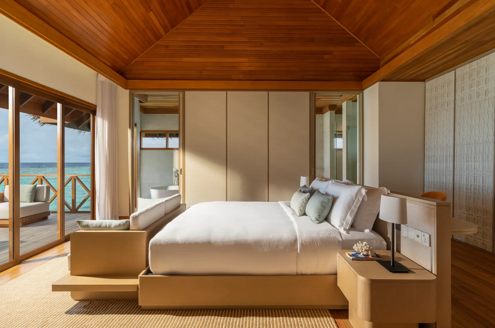 huvafen fushi maldives ocean pavilion with pool bed featuring a serene overwater sleeping space with elegant textures and tranquil lagoon views