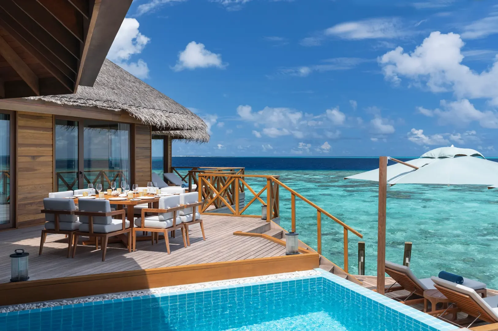 huvafen fushi maldives ocean pavilion with pool deck table featuring an elegant overwater dining setting with serene lagoon views and refined island ambience