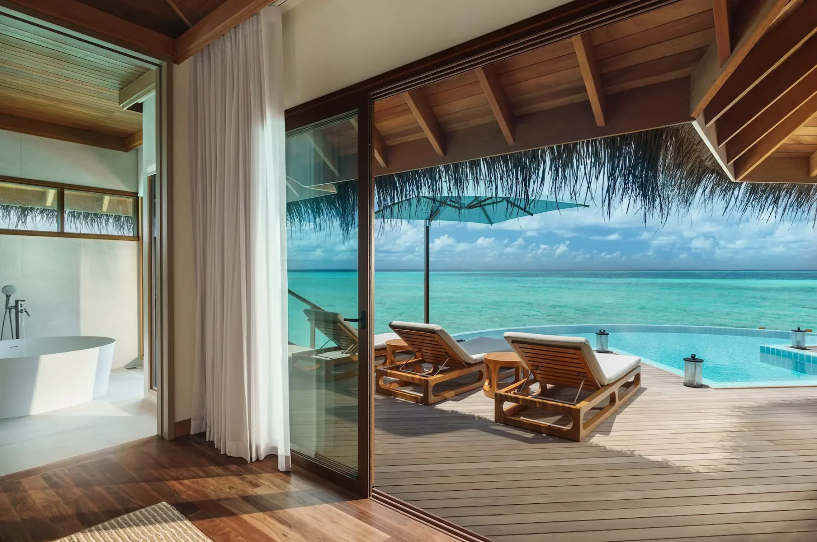 huvafen fushi maldives ocean pavilion with pool sunbeds offering a tranquil overwater lounging space