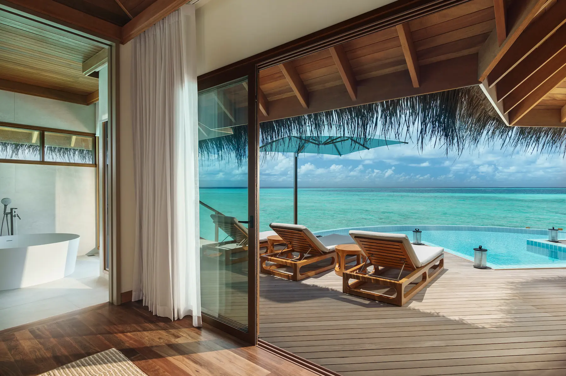 huvafen fushi maldives ocean pavilion with pool sunbeds offering a tranquil overwater lounging space