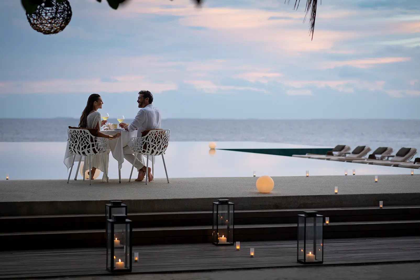huvafen fushi maldives pool dining offering an elegant waterside dining experience with refined island ambience and serene tropical surroundings