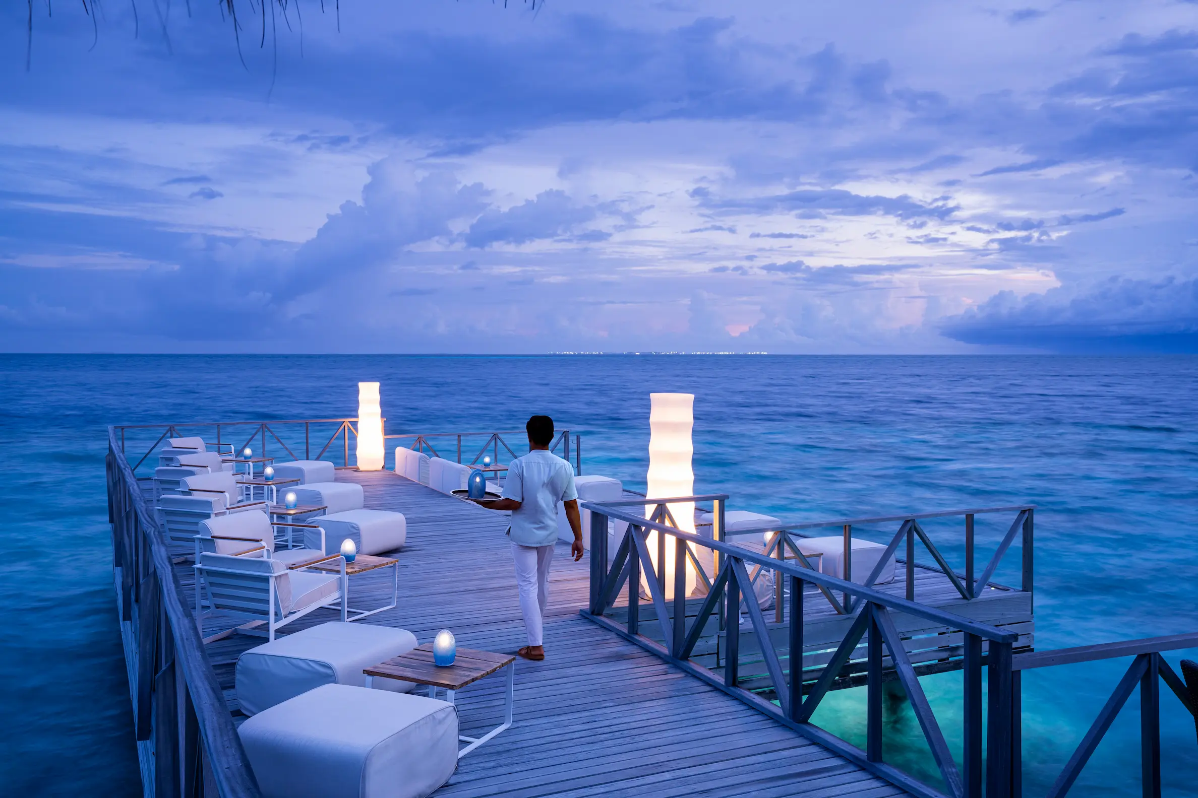 huvafen fushi maldives raw deck offering an elegant overwater dining terrace with serene lagoon views and refined island ambience