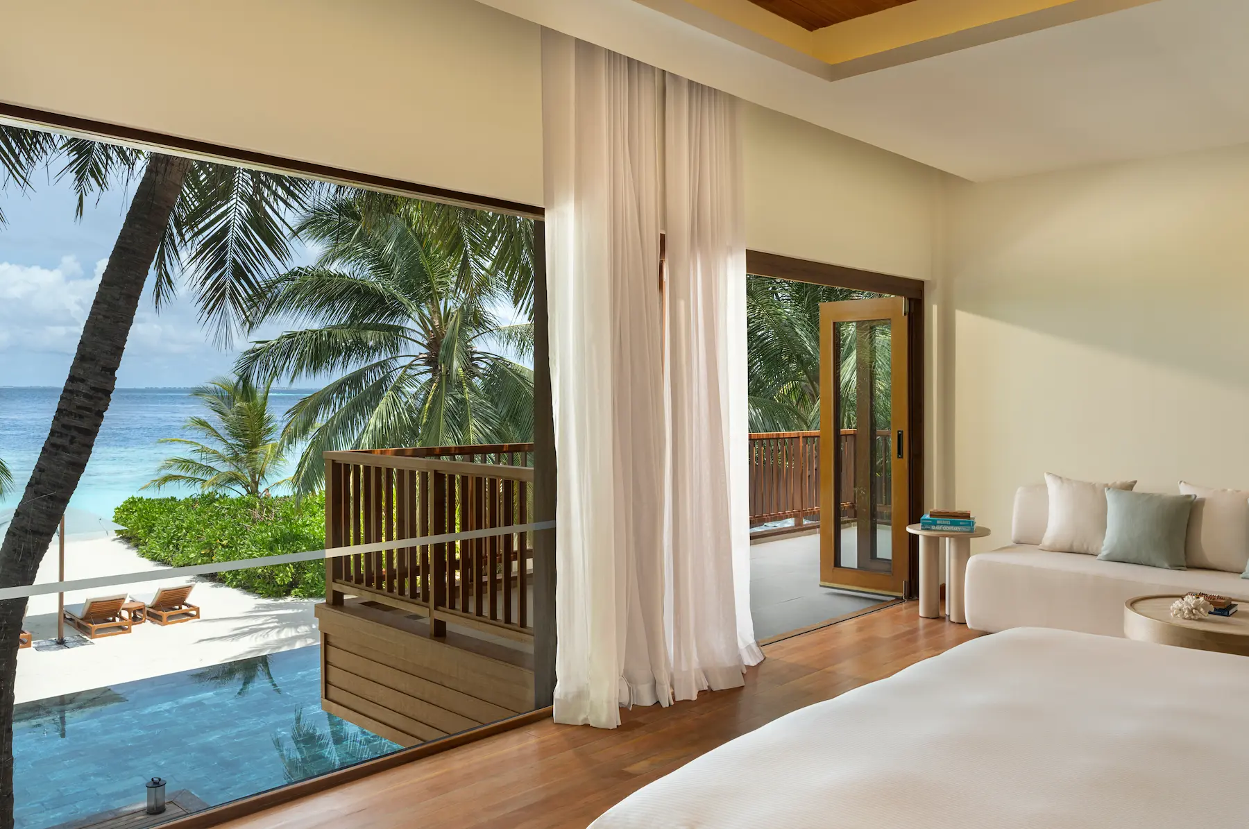 huvafen fushi maldives two bedroom beach house with pool balcony featuring an elevated beachfront viewpoint