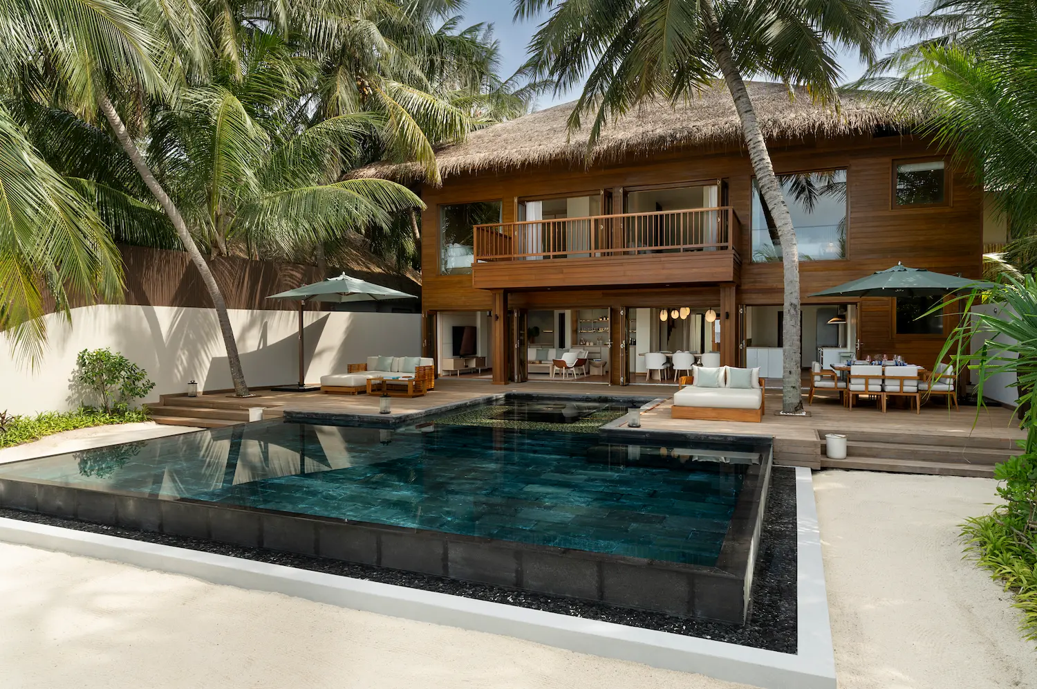 huvafen fushi maldives two bedroom beach house with pool sunbed offering a serene beachfront lounging space