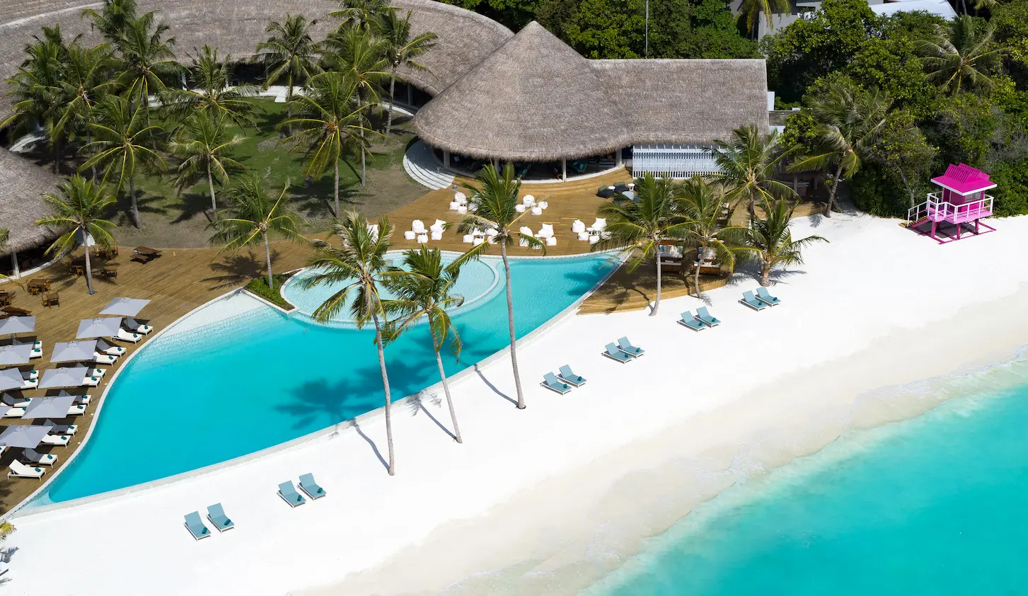 ifuru island maldives main pool and social house aerial sunbeds scene showcasing serene island luxury and elegant contemporary beachfront ambience