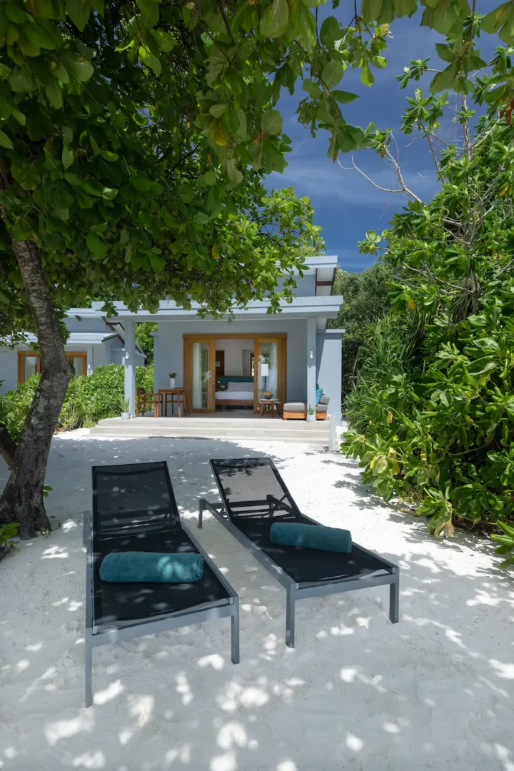 ifuru island maldives sunset beach villa exterior with serene island luxury and elegant contemporary beachfront design