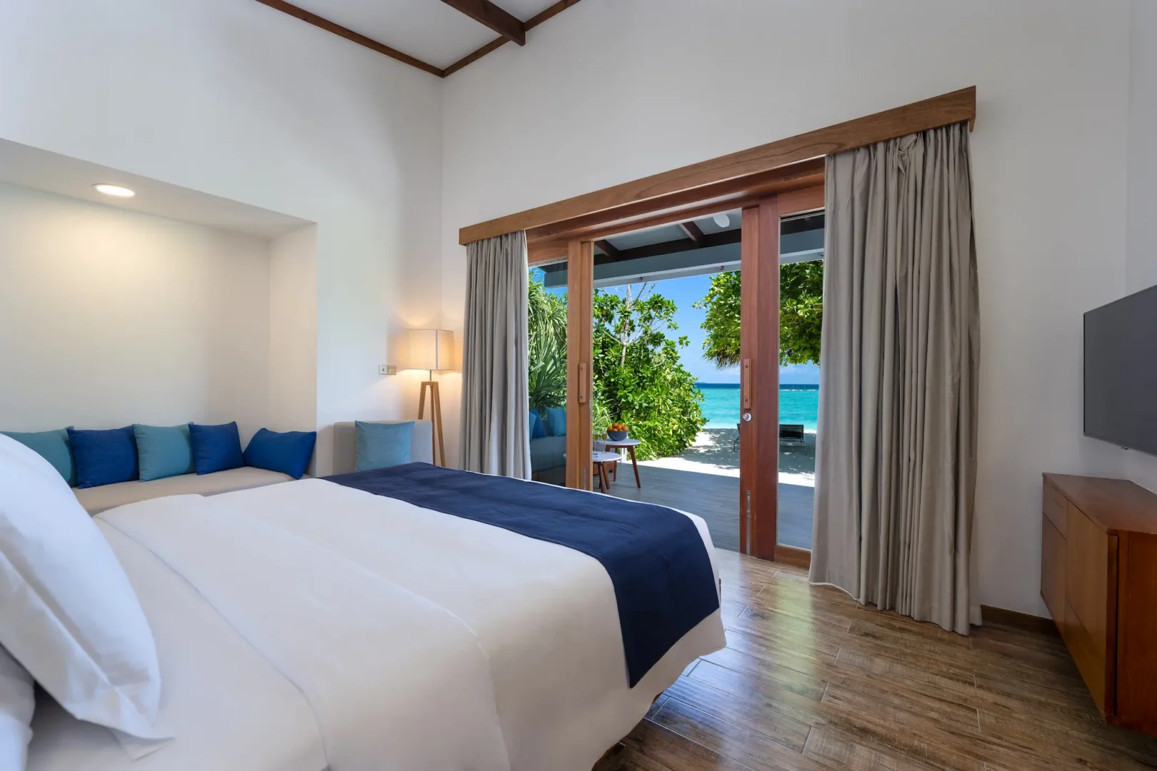 ifuru island maldives sunset beach villa interior with refined contemporary design and a serene luxury island atmosphere