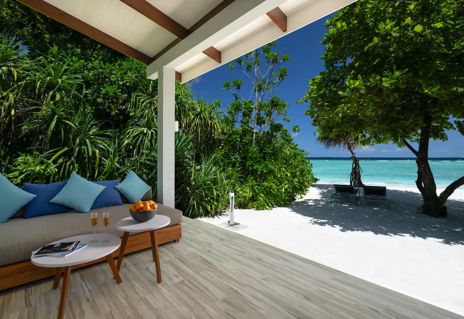 ifuru island maldives sunset beach villa outdoor terrace with serene island luxury and elegant contemporary beachfront ambience