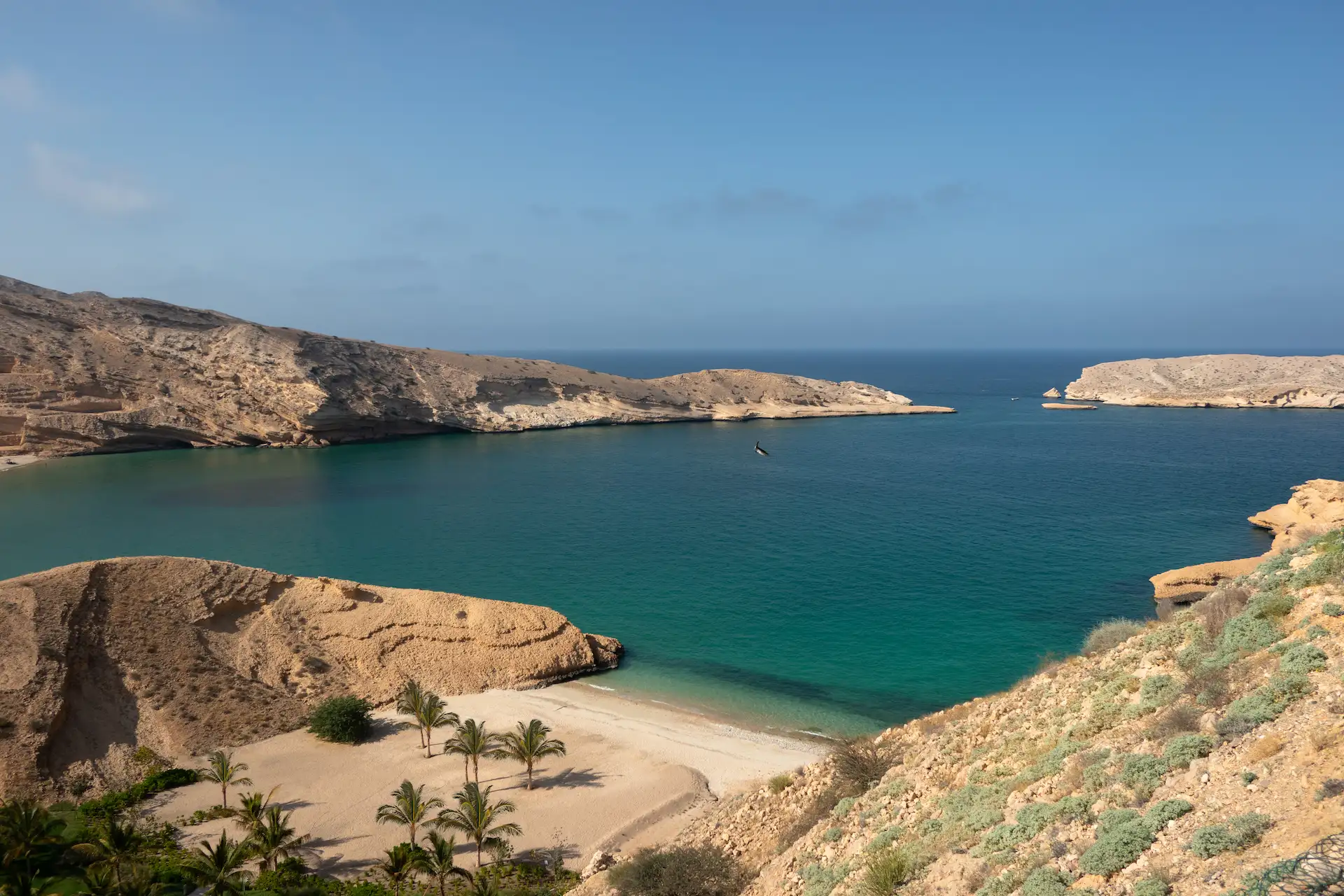 bay landscape at jumeirah muscat bay oman featuring dramatic coastline turquoise waters and surrounding rocky mountains in a luxury resort setting