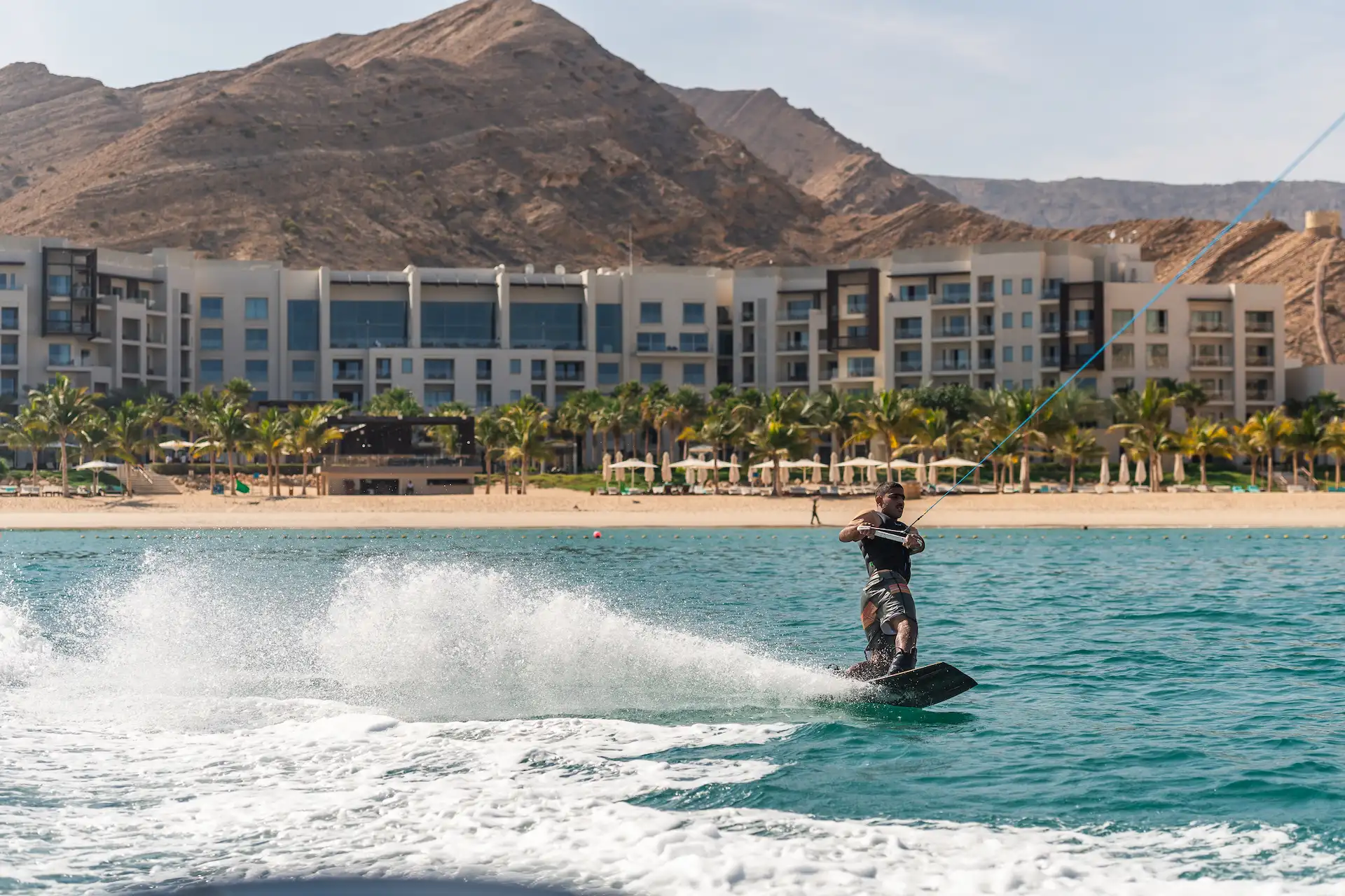 water sports at jumeirah muscat bay oman including kayaking paddleboarding and beach activities along the resort coastline