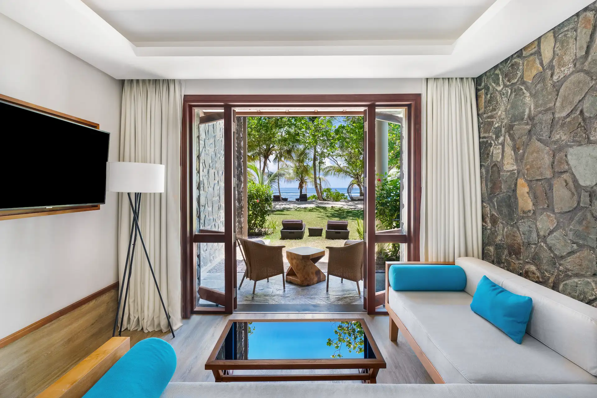 kempinski seychelles resort deluxe ocean view garden room with double doors opening to garden