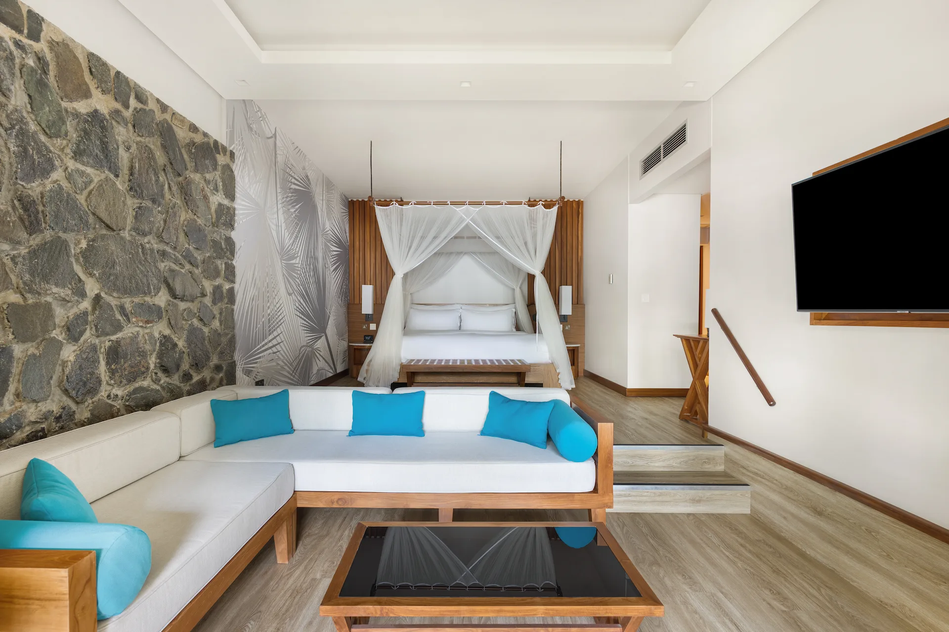 kempinski seychelles resort deluxe ocean view garden room lounge area with seating and garden view