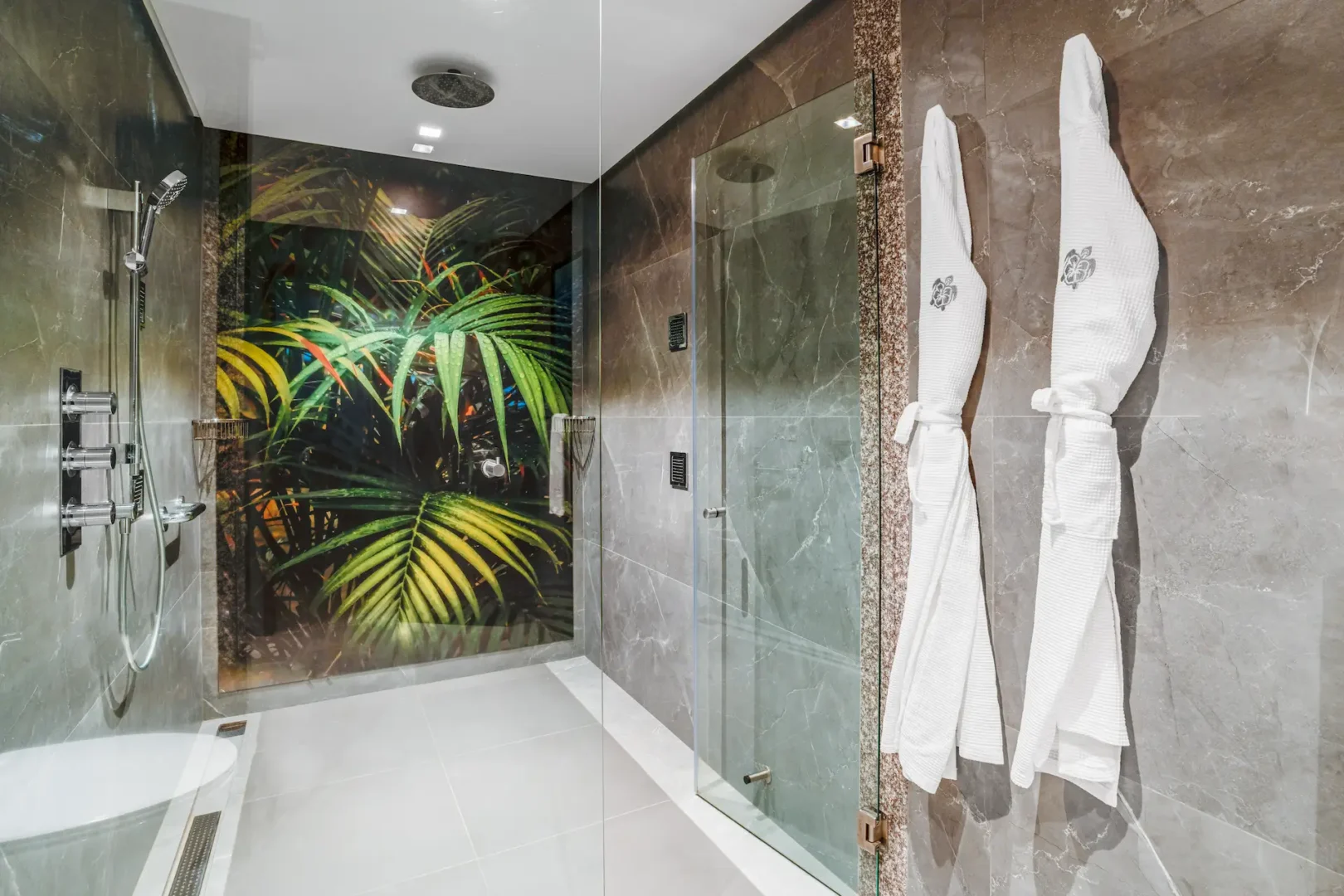 kempinski seychelles resort deluxe ocean view garden room bathroom with shower and garden view