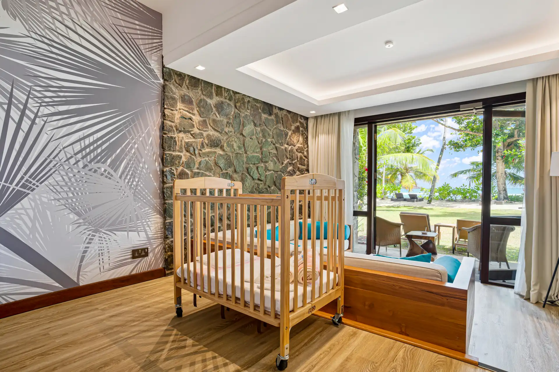kempinski seychelles resort family room with cot and ocean view