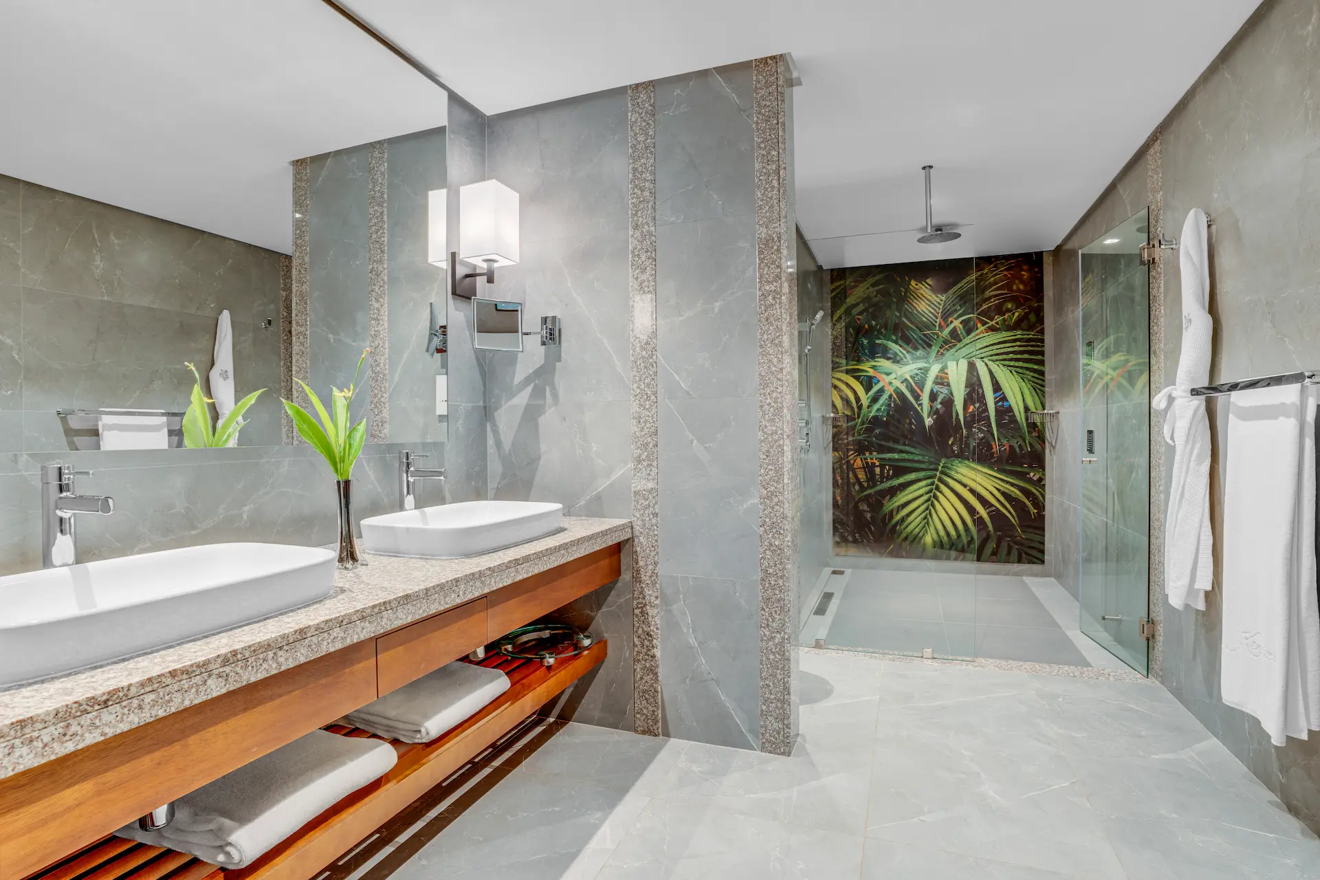 kempinski seychelles resort family room bathroom with sinks and ocean view