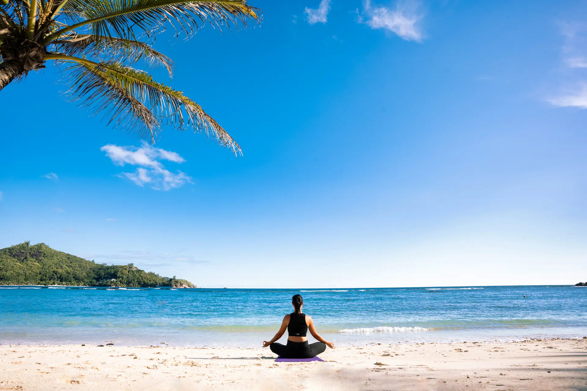 kempinski seychelles resort yoga session on deck overlooking ocean