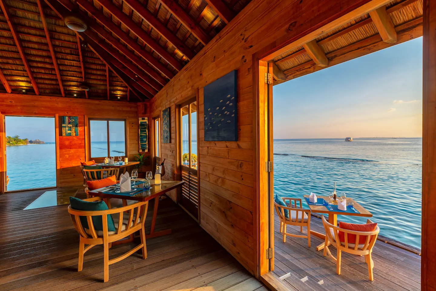 komandoo maldives aqua restaurant interior showcasing elegant island dining and serene overwater ambiance