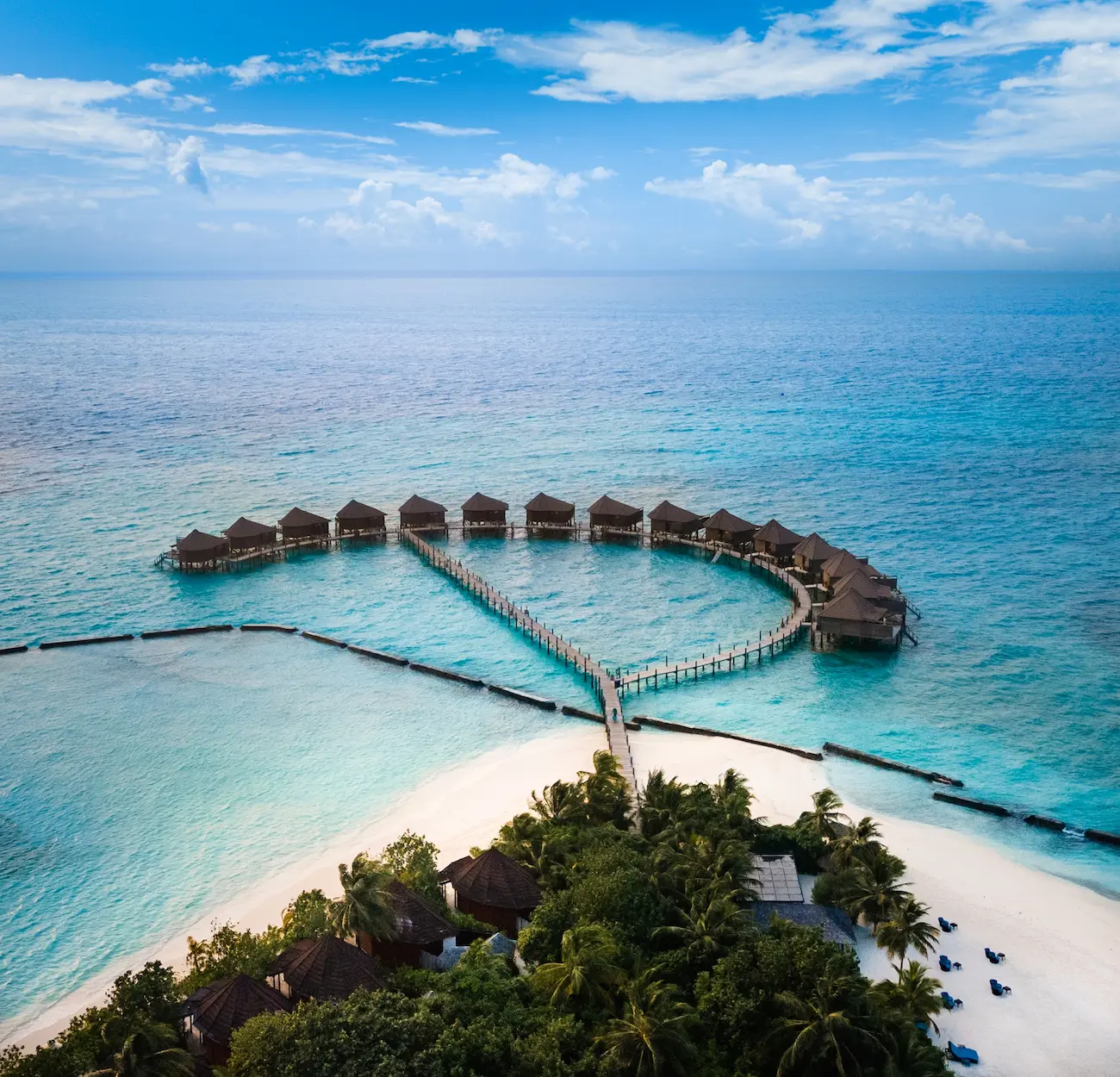 komandoo maldives jacuzzi water villa aerial view showcasing serene overwater luxury and turquoise lagoon scenery