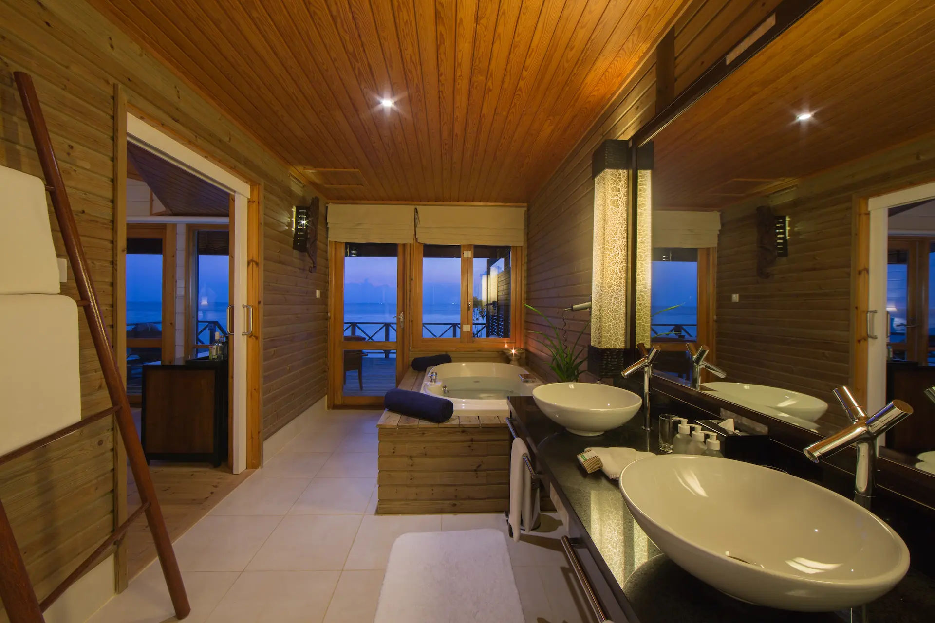 komandoo maldives jacuzzi water villa bathroom bathtub offering serene overwater luxury and soothing island ambience