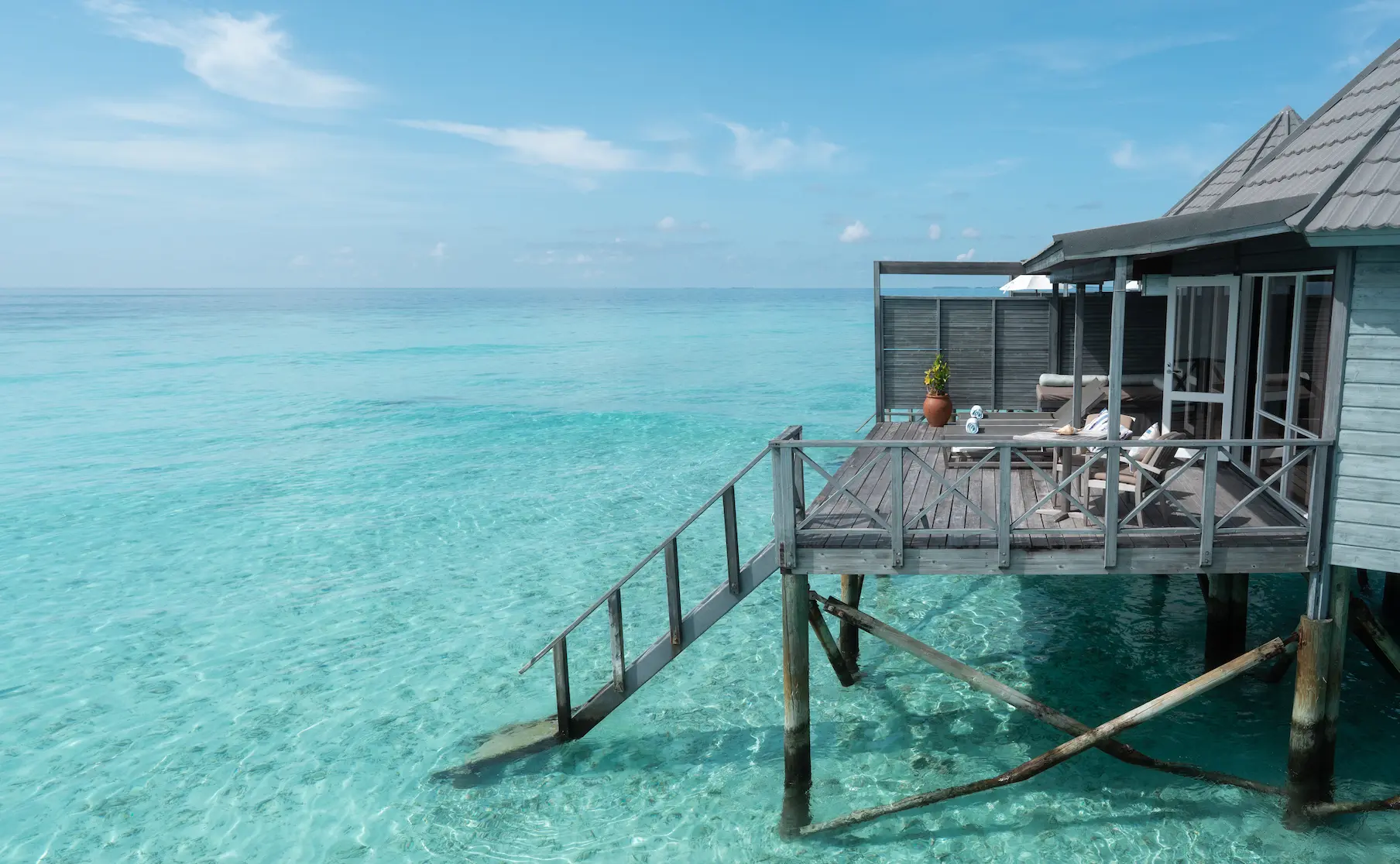 komandoo maldives jacuzzi water villa deck with stairs to lagoon showcasing tranquil overwater luxury and direct ocean access