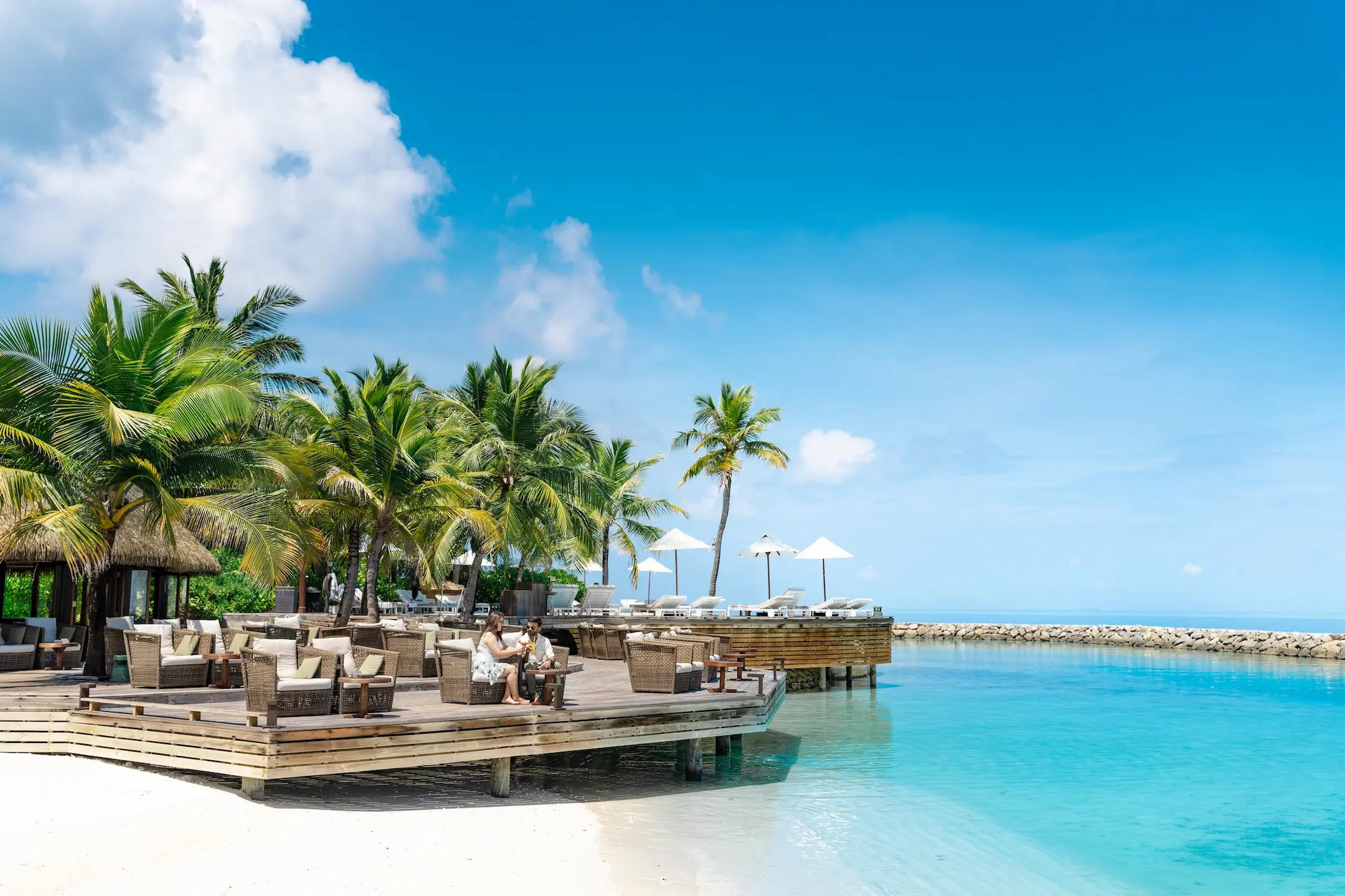 komandoo maldives kandu bar showcasing relaxed island luxury and elegant oceanside ambience