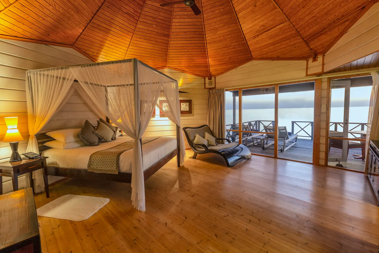 komandoo maldives ocean jacuzzi water villa interior bed with view showcasing serene overwater luxury and panoramic lagoon scenery