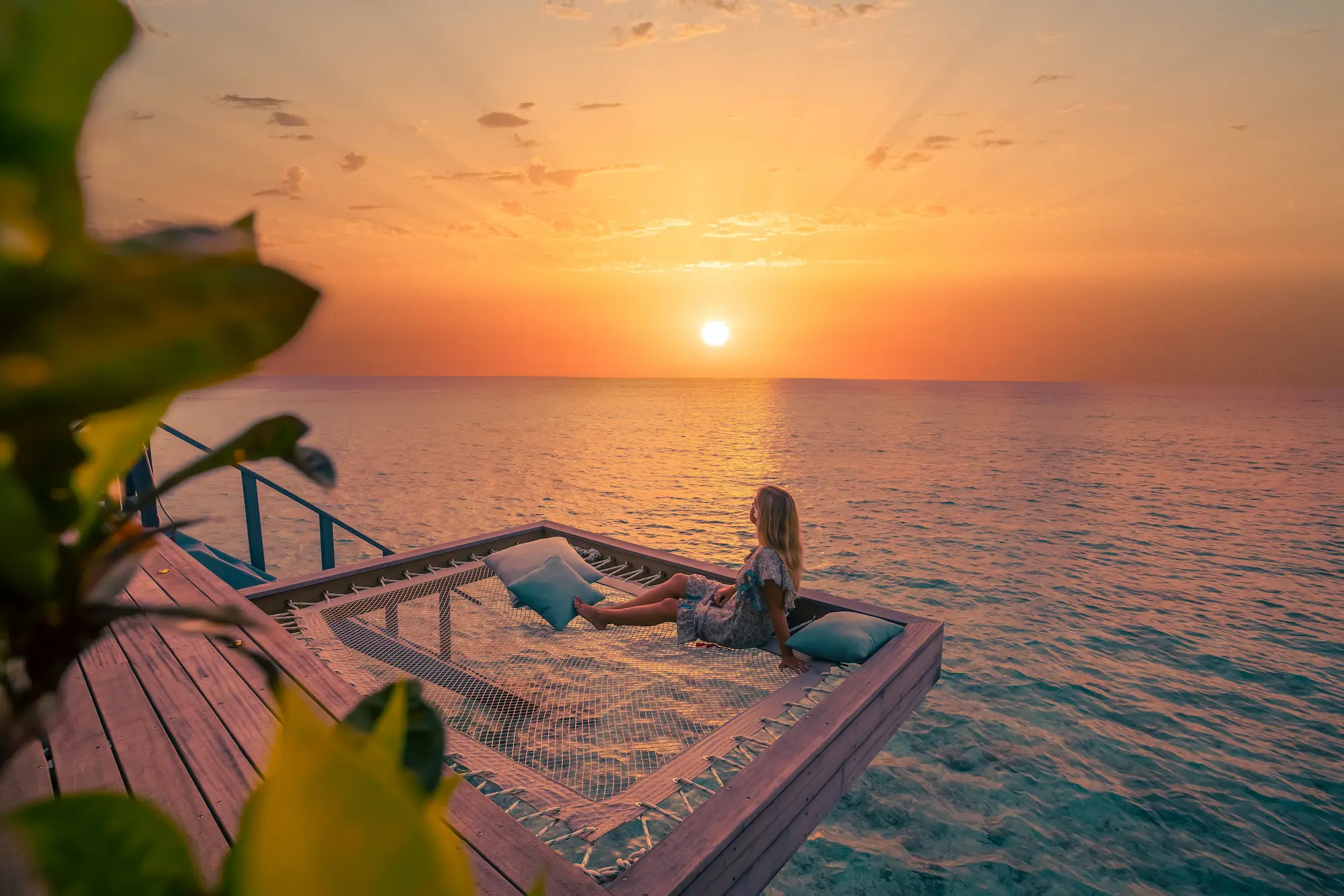 komandoo maldives ocean jacuzzi water villa at sunset showcasing serene overwater luxury and warm island glow
