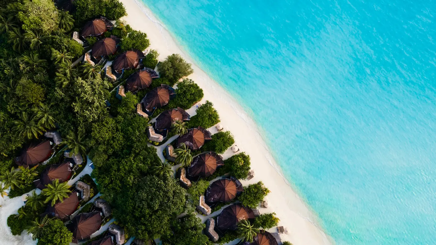 komandoo maldives premium jacuzzi beach villa aerial view showcasing tranquil island luxury and crystal lagoon surroundings