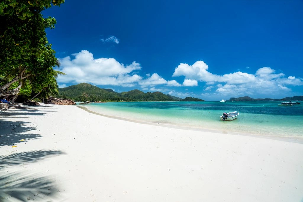 larchipel seychelles anse gouvernement beach with white sand and turquoise water surrounded by tropical greenery