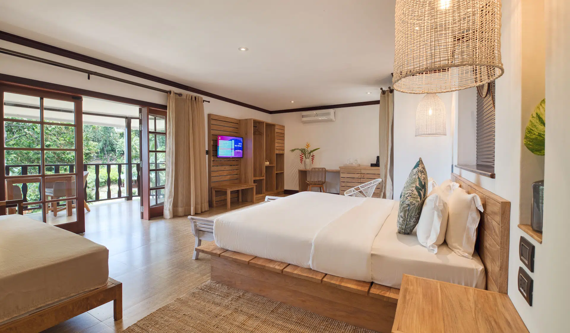 larchipel seychelles deluxe room view of bed with tropical balcony and ocean scenery