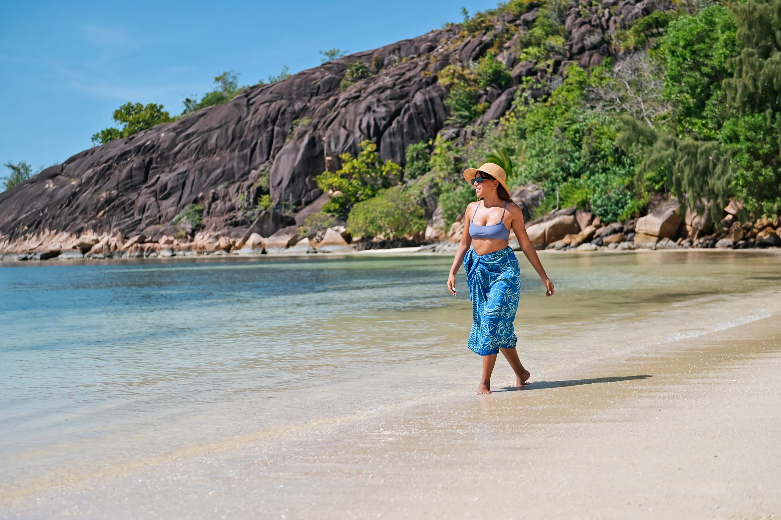 larchipel seychelles couple strolling along beach with turquoise waters