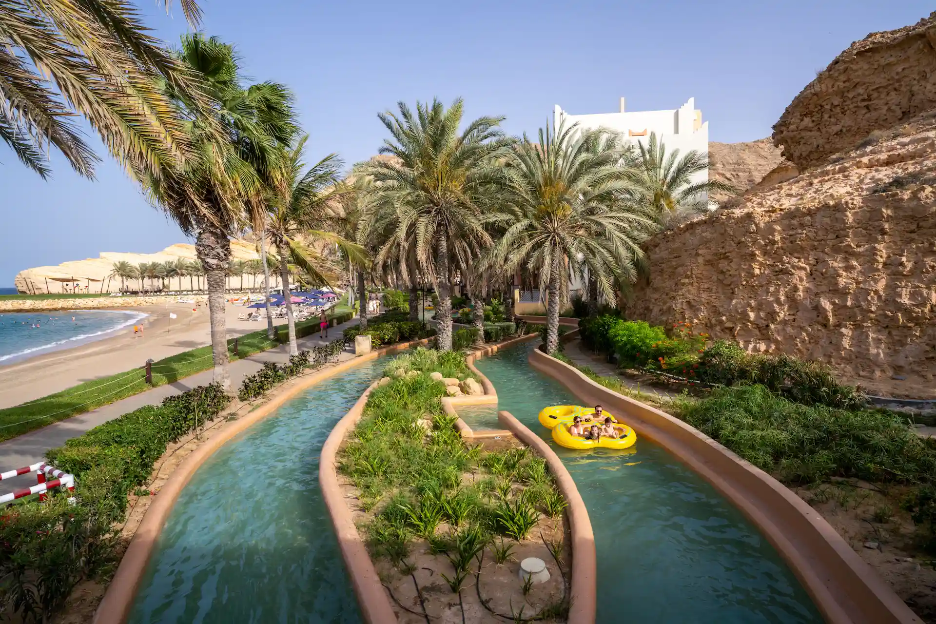 guests enjoying the lazy river at hilton muscat al bandar oman resort
