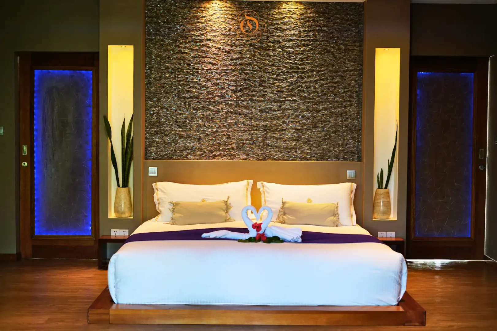 bed in a garden suite at Le Domaine de L’Orangeraie Resort & Spa with a comfortable large bed and views of lush tropical surroundings