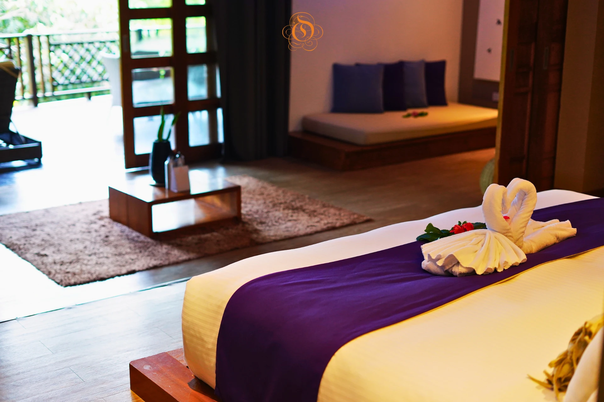 view from the bed in a garden suite at Le Domaine de L’Orangeraie Resort & Spa overlooking tropical greenery through large windows
