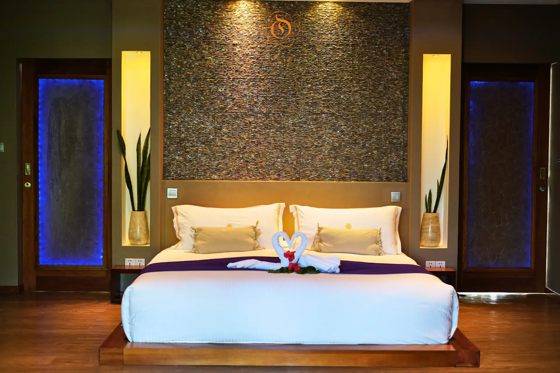 bed in a garden suite at Le Domaine de L’Orangeraie Resort & Spa with a comfortable large bed and views of lush tropical surroundings