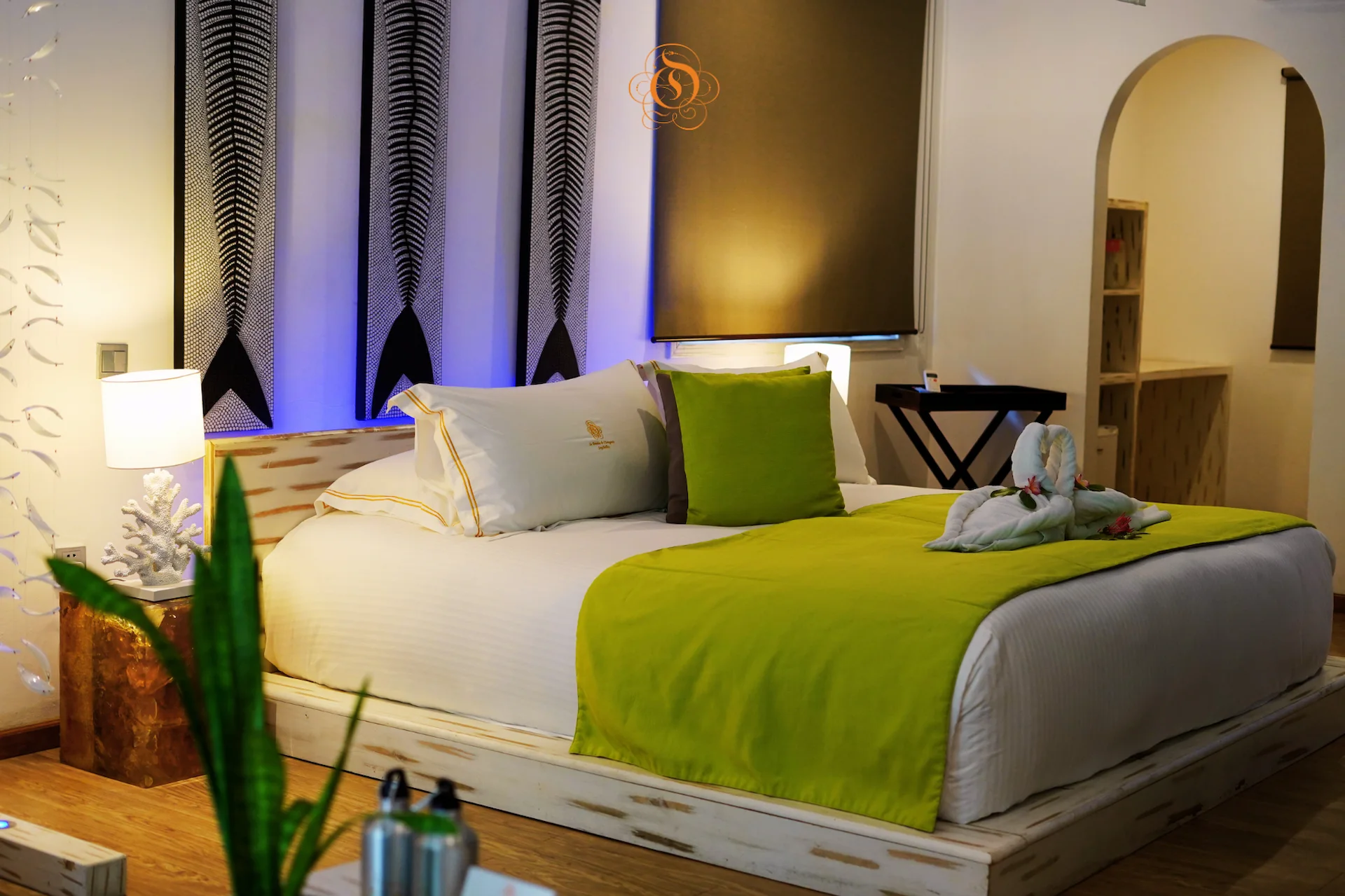 bedroom in a garden villa at Le Domaine de L’Orangeraie Resort & Spa with a large bed and tropical inspired interior design