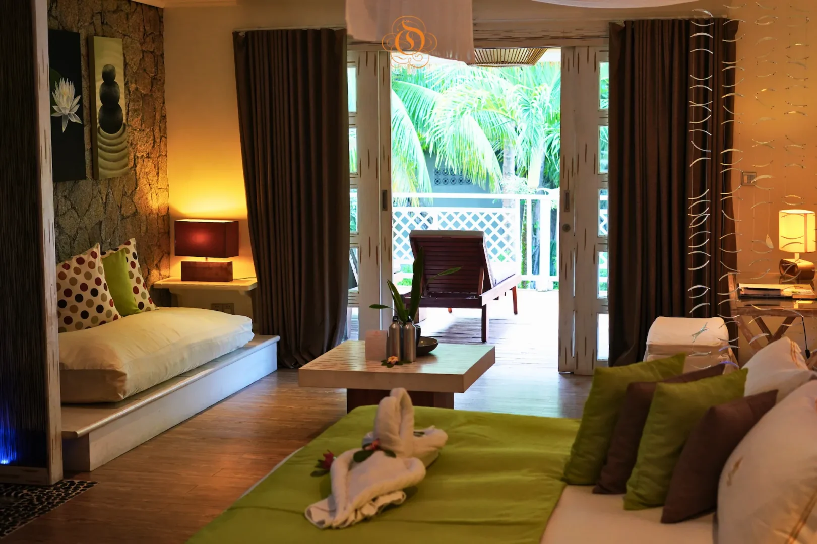 lounge area of a garden villa at Le Domaine de L’Orangeraie Resort & Spa with comfortable seating and tropical garden surroundings