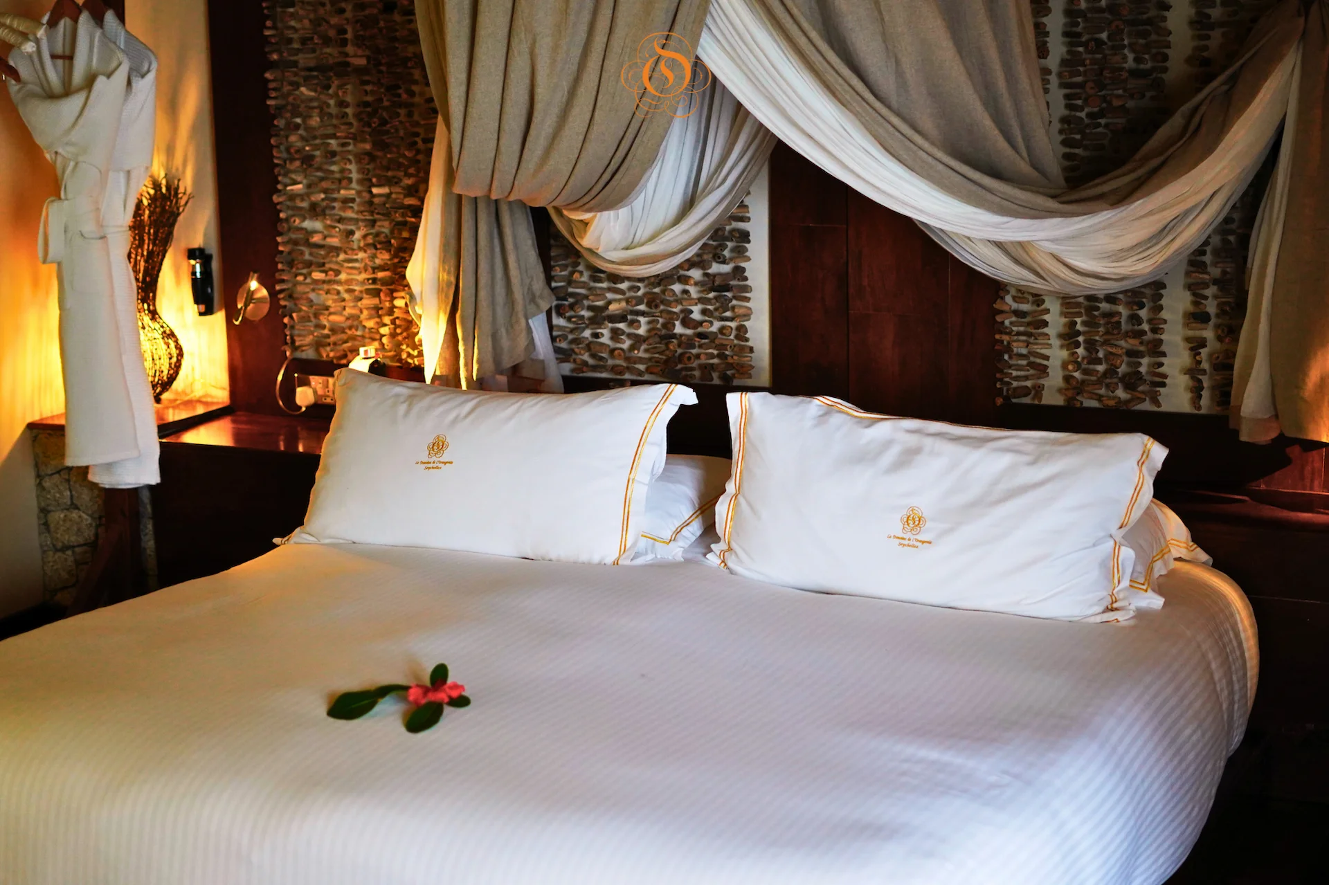 bedroom in a presidential villa at Le Domaine de L’Orangeraie Resort & Spa with a spacious bed and elegant tropical interior design